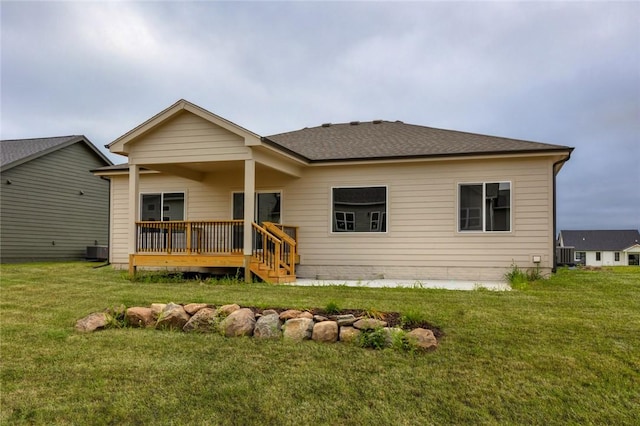 back of house featuring central AC, a lawn, and a deck