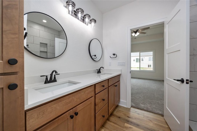 bathroom featuring ceiling fan, hardwood / wood-style floors, and dual bowl vanity