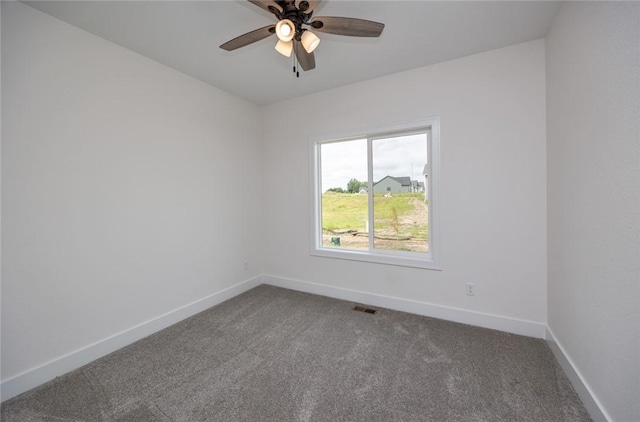 carpeted empty room featuring ceiling fan