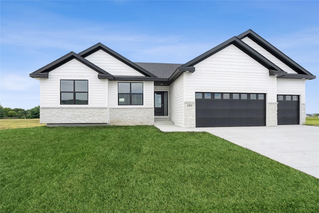 view of front of home with a front lawn and a garage