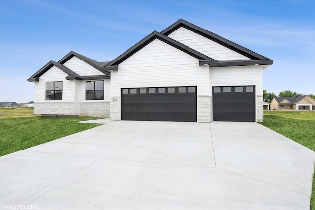 modern farmhouse style home with a garage and a front lawn