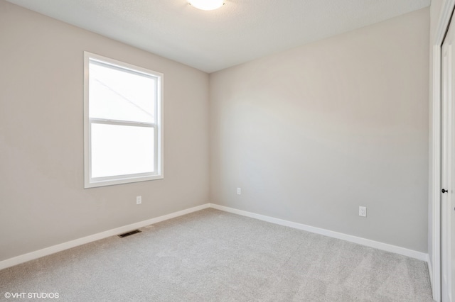 carpeted empty room with a healthy amount of sunlight