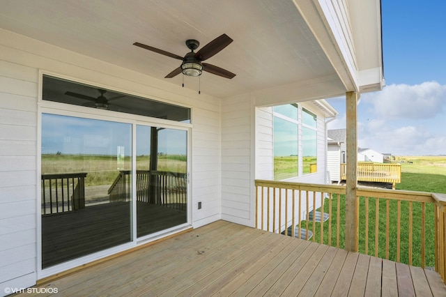 wooden terrace with a yard and ceiling fan