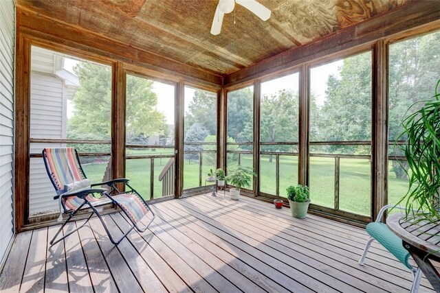 unfurnished sunroom with a wealth of natural light and ceiling fan