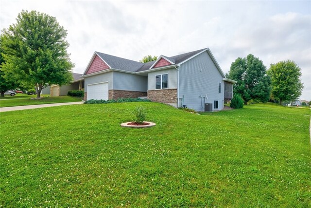 view of side of home with a garage and a lawn