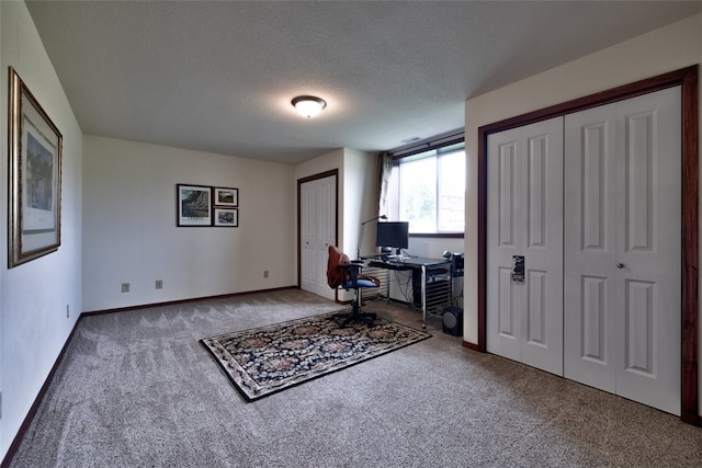 office space featuring carpet floors and a textured ceiling