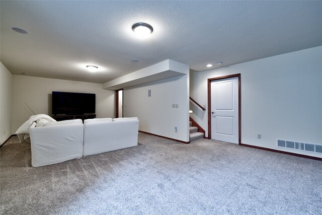 unfurnished living room with carpet and a textured ceiling