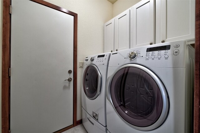 laundry room with cabinets and washer and dryer