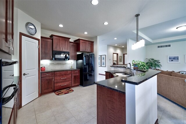 kitchen with decorative backsplash, sink, black appliances, and light tile patterned floors