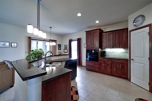 kitchen with sink, light tile patterned flooring, black appliances, and an island with sink