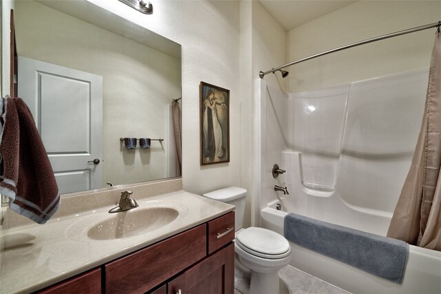 full bathroom with tile patterned flooring, shower / bath combo with shower curtain, toilet, and vanity