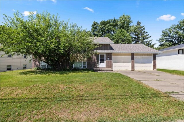 view of front of house with a garage and a front yard