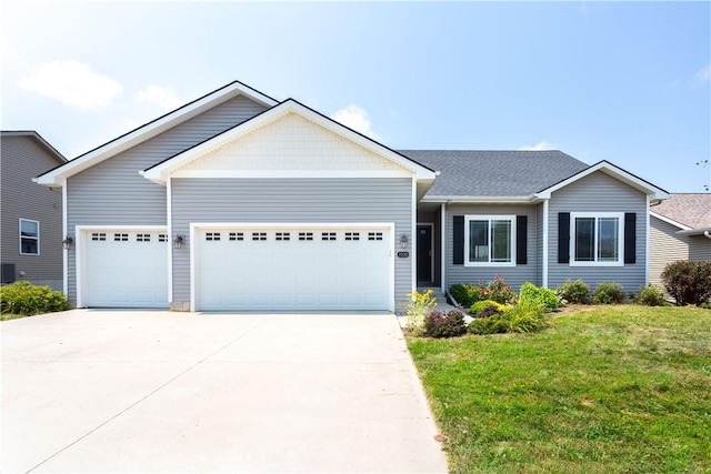 view of front facade with cooling unit, a garage, and a front lawn