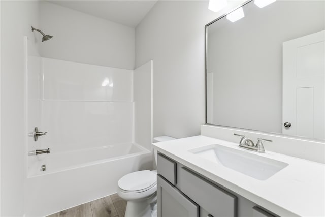 full bathroom with shower / bathing tub combination, hardwood / wood-style floors, vanity, and toilet