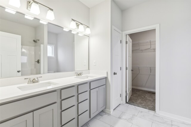 bathroom featuring toilet, vanity, and walk in shower