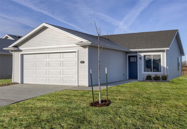 single story home featuring a garage and a front lawn