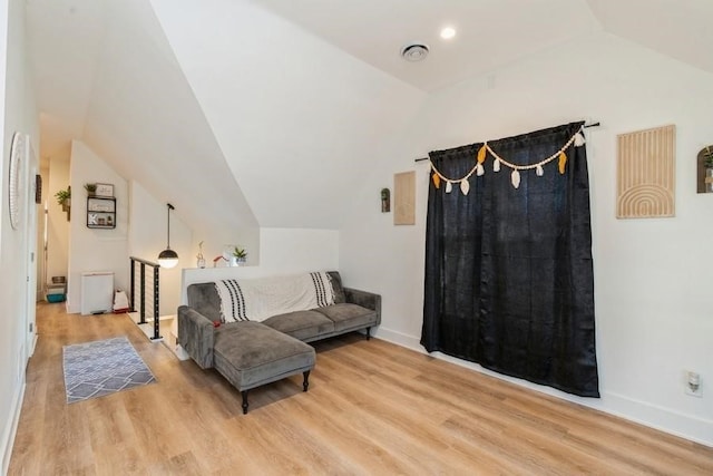 interior space with light hardwood / wood-style floors and lofted ceiling