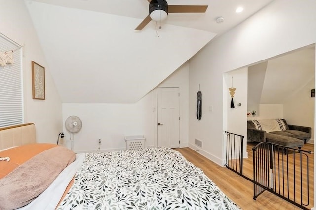 bedroom featuring ceiling fan, light wood-type flooring, and vaulted ceiling