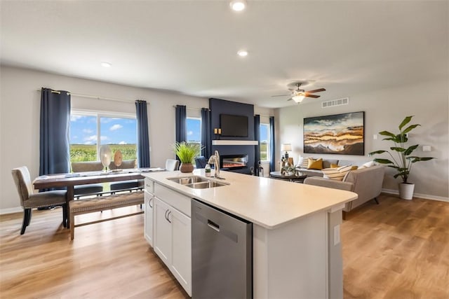 kitchen with sink, light hardwood / wood-style flooring, dishwasher, an island with sink, and white cabinets