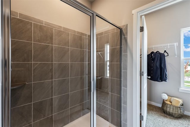 bathroom with a shower with door