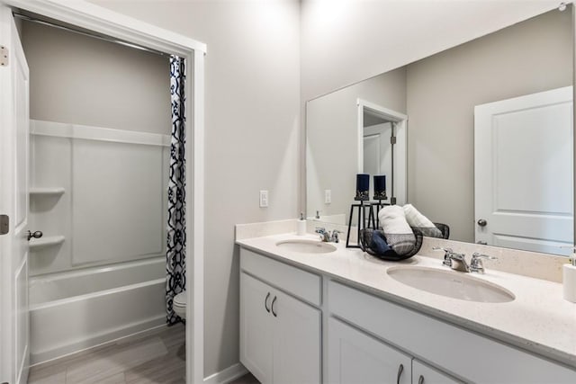 full bathroom with hardwood / wood-style flooring, vanity, toilet, and shower / bath combo with shower curtain