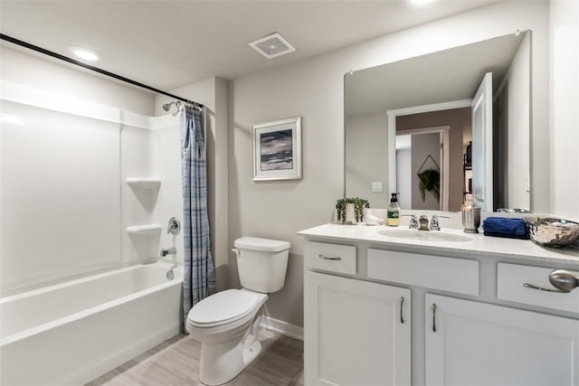 full bathroom featuring shower / bathtub combination with curtain, vanity, hardwood / wood-style flooring, and toilet