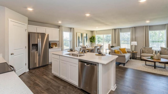 kitchen featuring an island with sink, stainless steel appliances, sink, and white cabinets