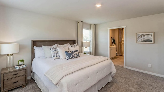 carpeted bedroom featuring connected bathroom