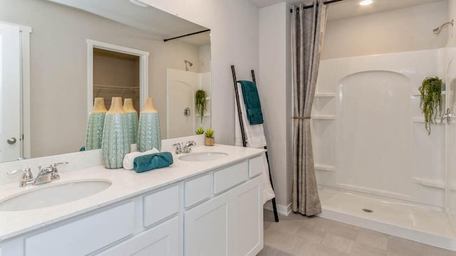 bathroom with vanity, tile patterned floors, and a shower