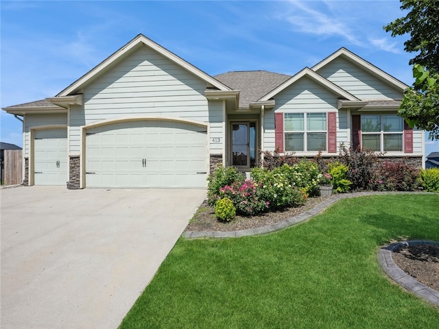 view of front of property with a garage and a front yard