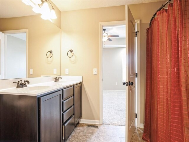 bathroom with double vanity, a textured ceiling, tile patterned floors, and ceiling fan