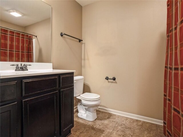 bathroom with vanity, tile patterned floors, and toilet