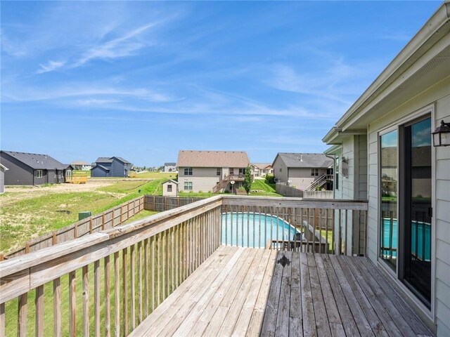 wooden terrace with a fenced in pool