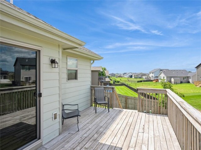 wooden terrace with a lawn