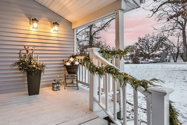 view of snow covered back of property