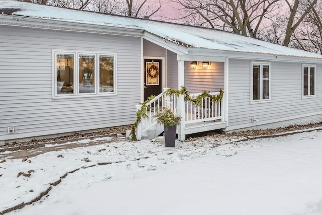 view of snow covered property entrance