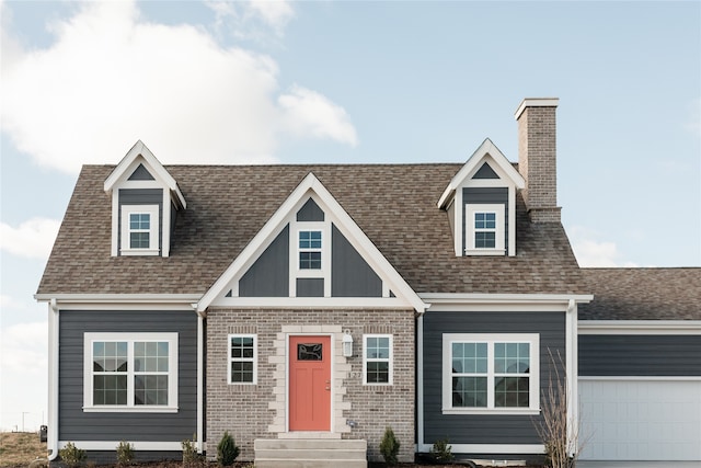 cape cod home with a garage