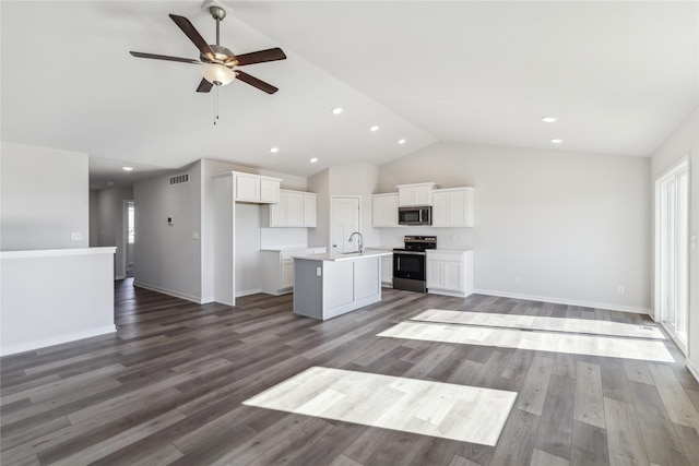 kitchen with visible vents, open floor plan, a kitchen island with sink, and stainless steel appliances