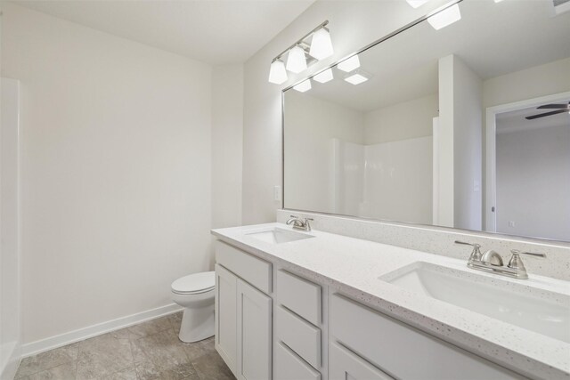 bathroom featuring a shower, vanity, and toilet