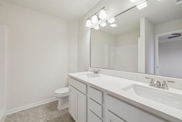 bathroom featuring vanity, a shower, and toilet