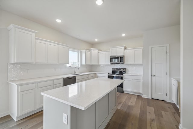 kitchen featuring a center island, white cabinetry, and appliances with stainless steel finishes