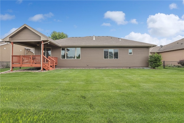 back of house with a lawn and a wooden deck