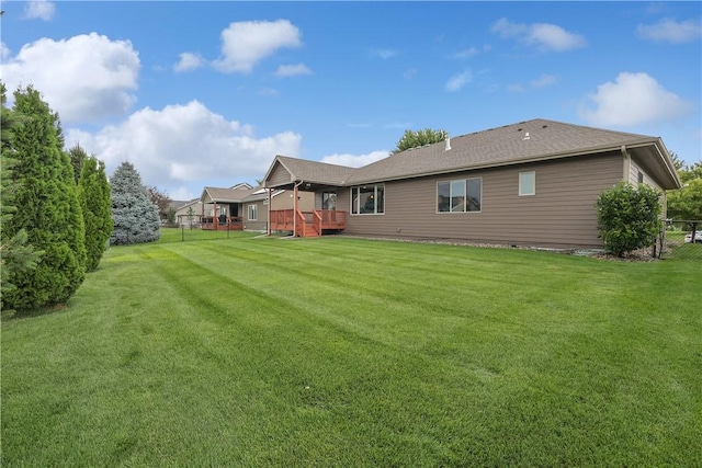 rear view of property with a yard