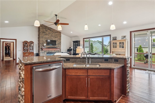 kitchen featuring dark wood-type flooring, sink, hanging light fixtures, vaulted ceiling, and stainless steel dishwasher