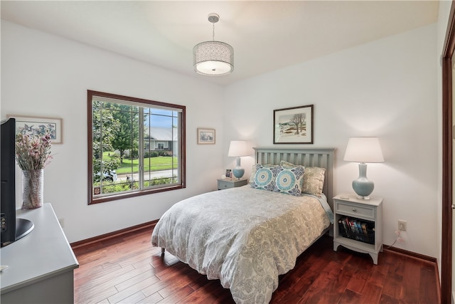 bedroom with dark hardwood / wood-style flooring