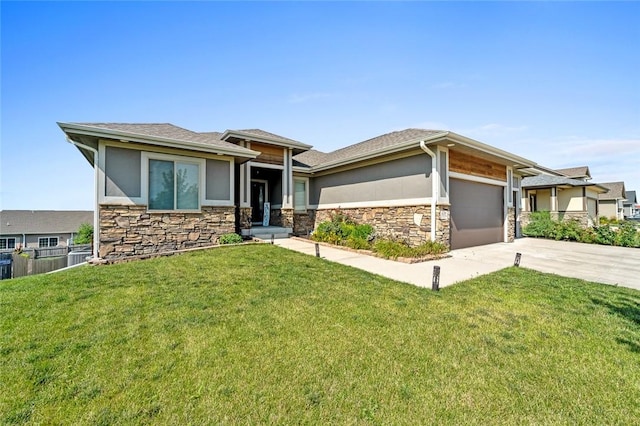 prairie-style home with a garage and a front lawn