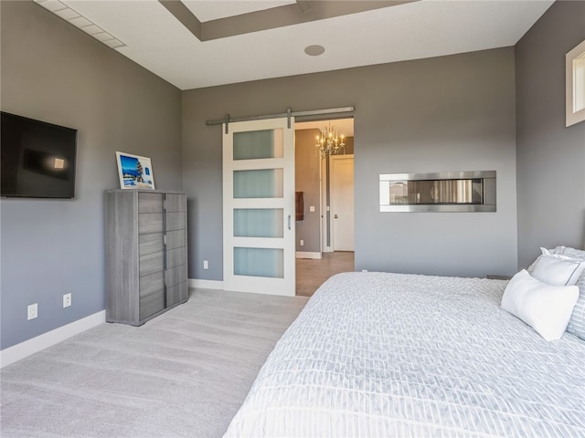 carpeted bedroom featuring a barn door