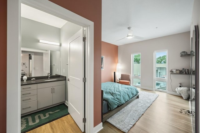 bedroom with sink, access to outside, ceiling fan, and light hardwood / wood-style flooring