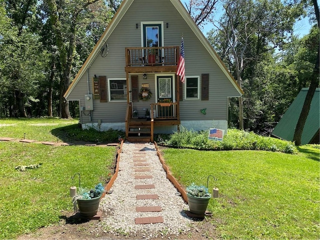 bungalow featuring a front yard and a balcony