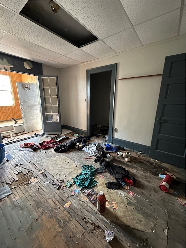 interior space with hardwood / wood-style flooring and a drop ceiling